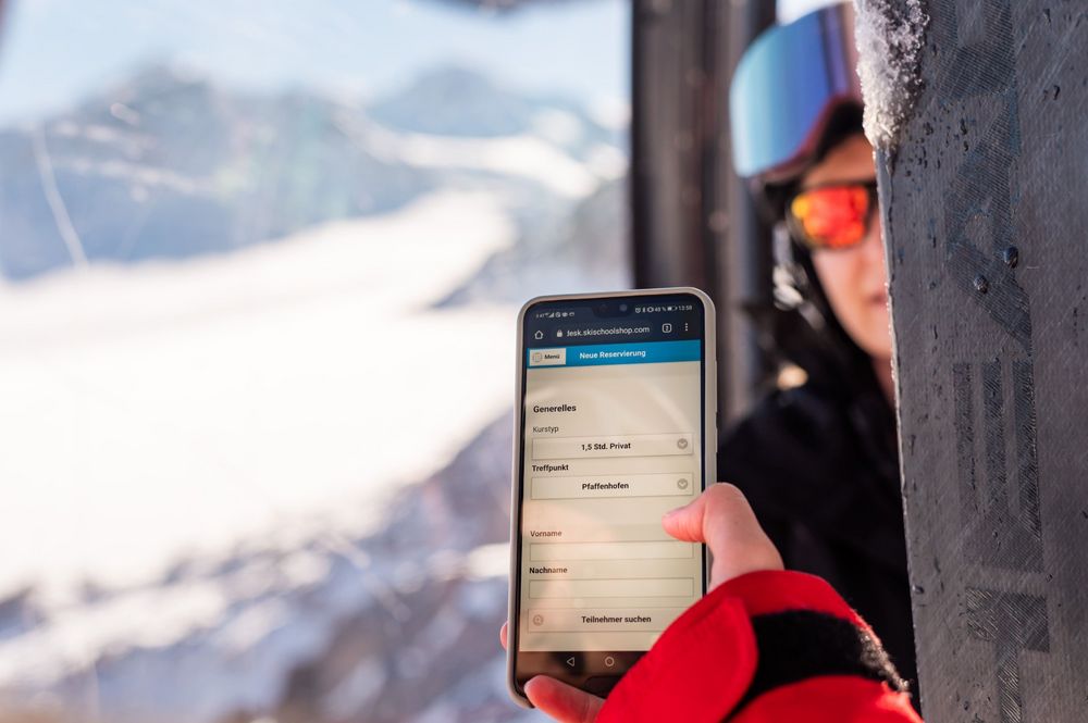 Ski instructor uses the ski instructor app in the gondola